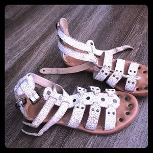 Pair of size 7 cracked white Frye sandals.